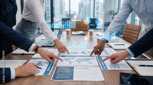 Business team meeting discussing financial reports and sales trends, hands pointing at documents with graphs, corporate strategy planning session, office teamwork and collaborat...