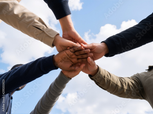 Hands United: Low-Angle Team Stack Beneath Open Sky—Unity, Trust, and 8K Collaborative Clarity