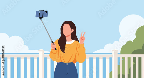 Faceless young woman in yellow sweater taking selfie using phone on a selfie stick with sea and clouds in background.