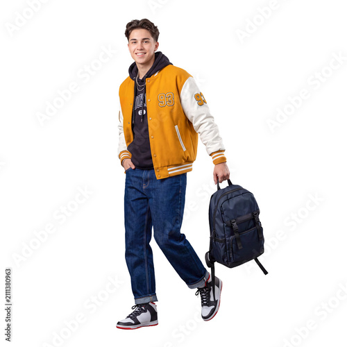 Isolated full body portrait of a happy young male student walking with backpack wearing yellow varsity jacket, representing college sports, university life, and back to school concept