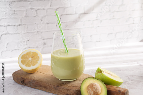 Green smoothie with avocado, lemon, and apple for wellness