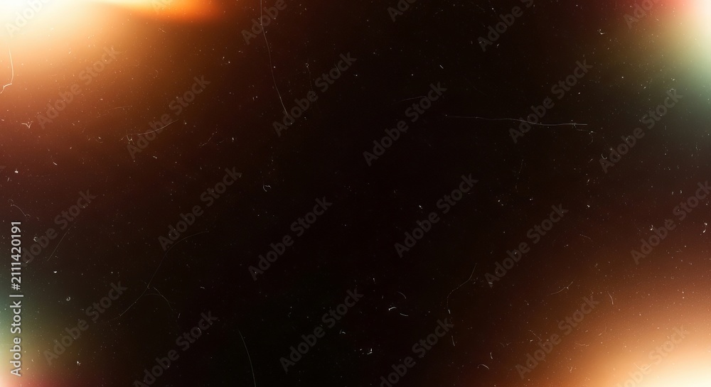 Fototapeta premium Vintage film texture overlay featuring glowing orange light leaks and dusty scratches on a dark black abstract photographic background surface