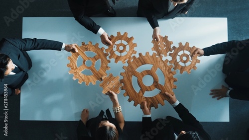 Obraz na płótnie Top view of professional business team bring filled last cog to complete system