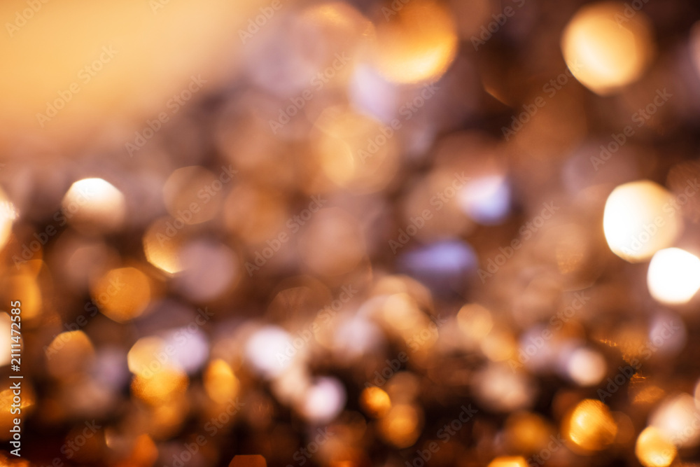 Fototapeta premium Golden glitter particles with soft focus, warm background