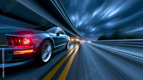 Fast cars racing on highway with motion blur at twilight  