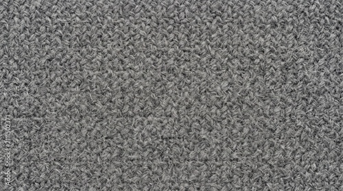 Detailed close-up of a gray wool fabric texture, featuring a soft woven pattern for elegant backgrounds.