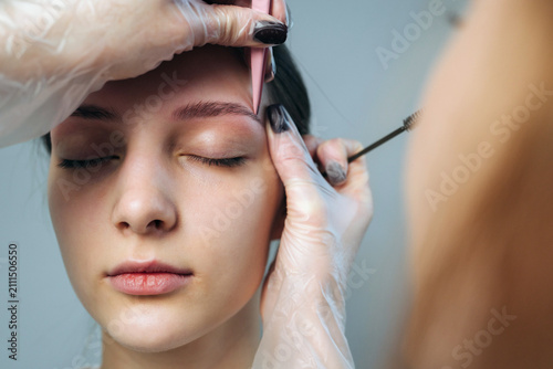 Woman getting eyebrow shaping in a beauty salon during a daytime appointment