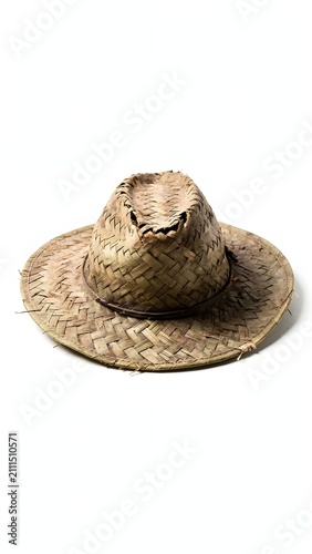 A rustic straw hat, handcrafted from natural fibers, sits isolated on a pristine white background, embodying a simple yet elegant accessory for sunny days