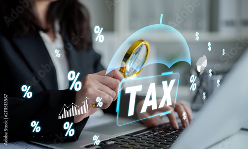 Konstfotografi Business Professional Analyzing Tax Information with Magnifying Glass and Digital Graphics on Laptop in Contemporary Office Setting