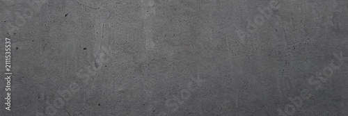 Industrial dark gray concrete texture background, weathered charcoal cement wall surface with grainy details, minimalist slate stone backdrop for architectural design and product mockup