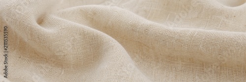 Natural beige linen fabric texture with soft wavy folds, organic hemp textile background for sustainable fashion, rustic woven canvas material for interior design and home decor
