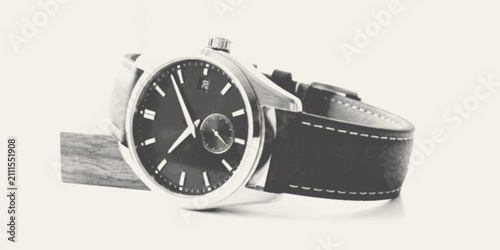 Canvas Print Elegant silver wristwatch with black leather strap on a minimalist wooden stand