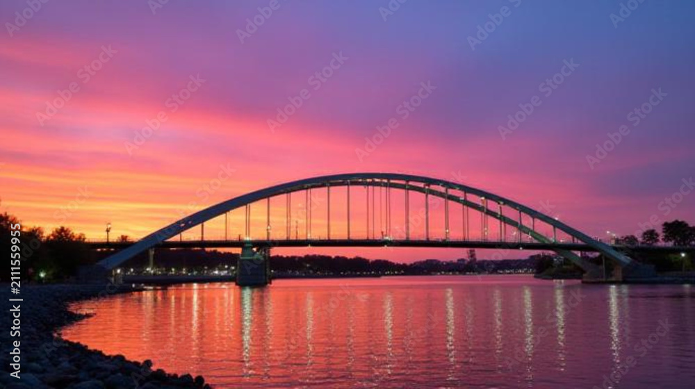 Fototapeta premium A bridge over a river seen from a distance at dusk. AI-generated.