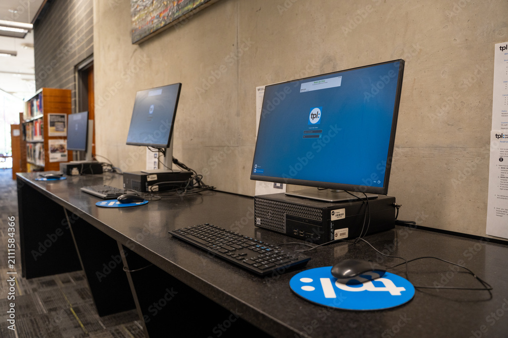 Obraz premium Public computer workstations inside Toronto Public Library. Toronto, Canada - July 24, 2026.