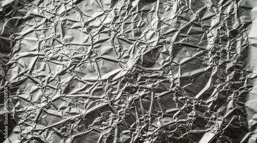 Crushed aluminum foil metallic t isolated on clean surface for modern commercial business asset