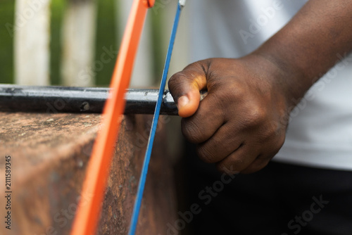 An hacksaw used in trimming a rod