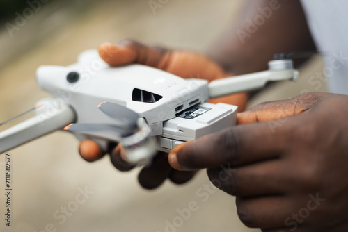 A person fixing the battery of a drone device