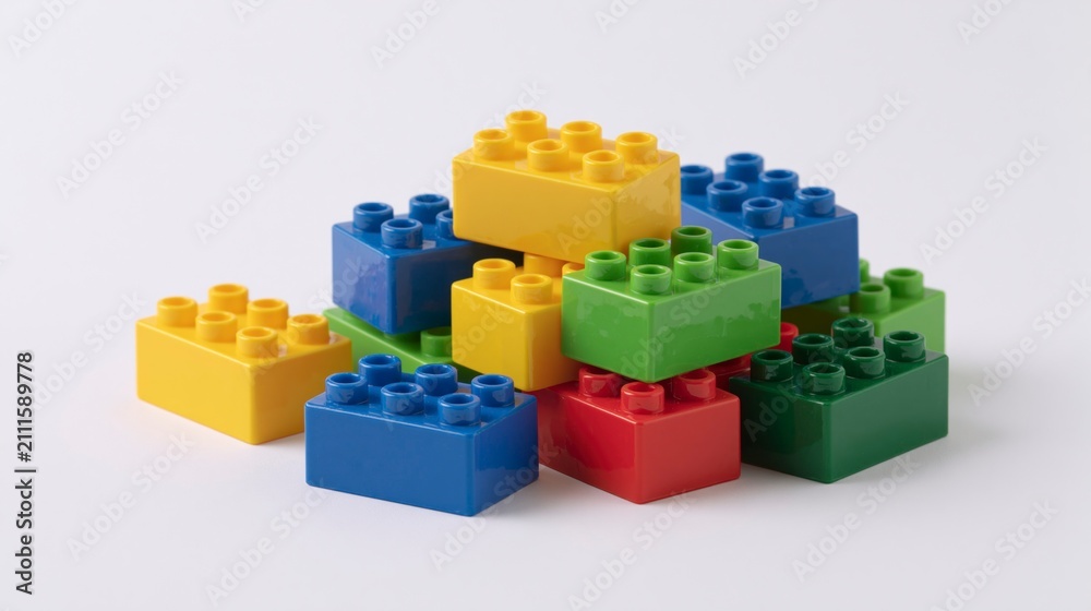 Fototapeta premium Pile of Colorful Plastic Building Blocks on a White Background
