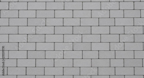 Gray paving stone texture background featuring clean rectangular bricks arranged in a uniform pattern for outdoor architectural design projects