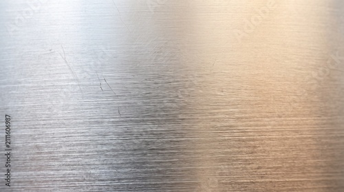 Fotografía Brushed metal texture background with horizontal lines and light reflections