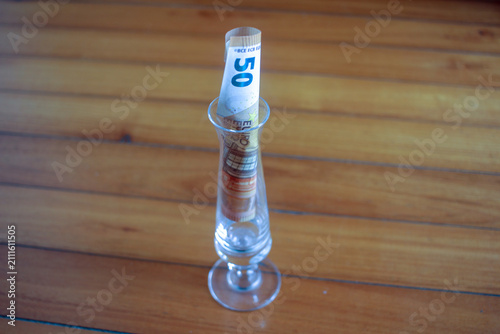 Принти на полотні Close Up View of Euro Note inside Glass Vase on Parquet Floor