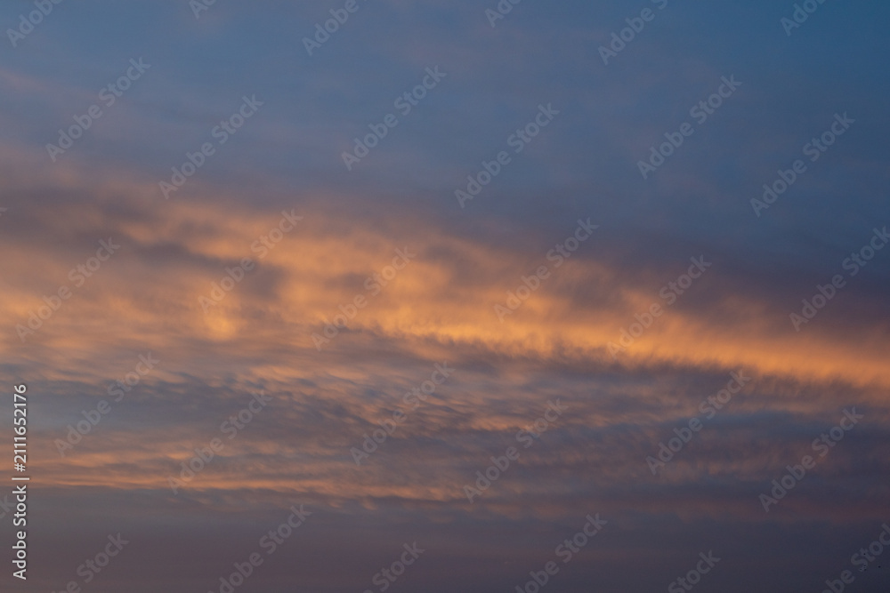 Obraz premium Sunset Clouds With Orange Hues
