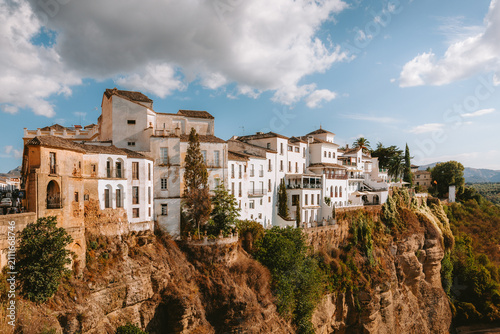 Ronda's traditional white houses line the edge of a dramatic cliff, showcasing the unique architecture and historical charm of this iconic city in Andalucia, Malaga