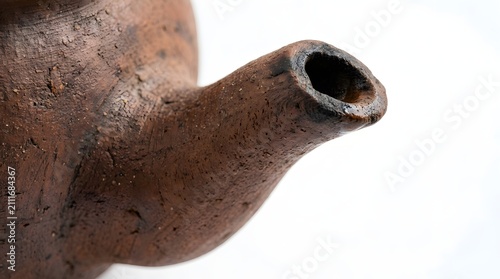 Traditional Indonesian earthenware teapot spout, a rustic clay vessel used for brewing aromatic tea