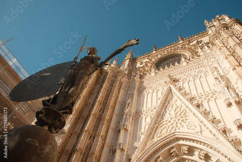  intricate exterior stonework of the Seville Cathedral, a UNESCO World Heritage site located in Seville, Spain, the largest Gothic cathedral in the world vertical