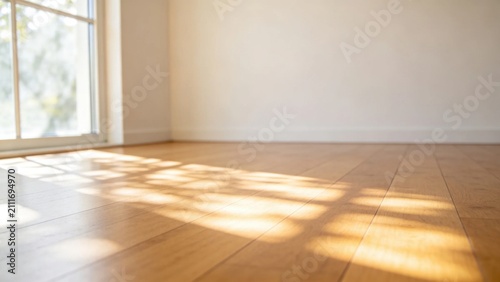 Sunlight streaming through window casting patterns on hardwo