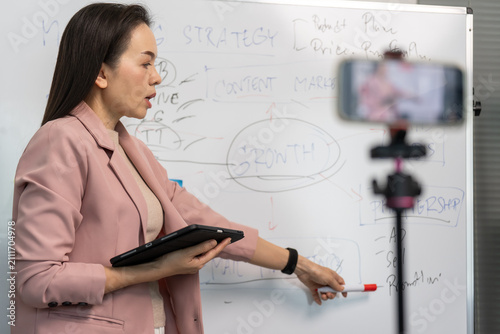 Фотография Woman teaches in a bright, modern classroom
