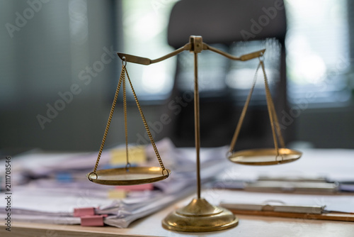 Obraz na płótnie Golden scales rest upon a cluttered desk