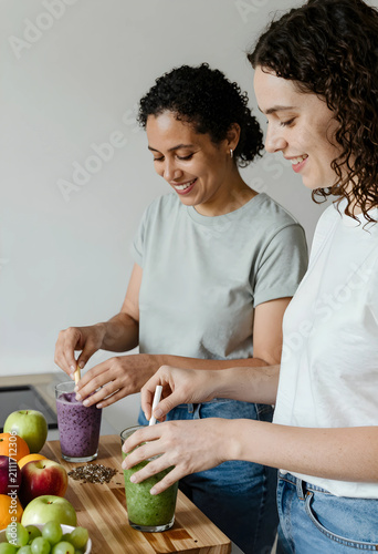 Two smiling women preparing...