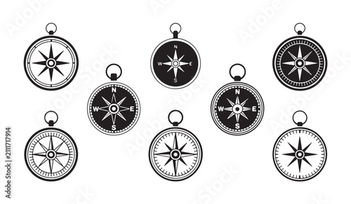 Collection of compasses and navigational symbols on a white background.