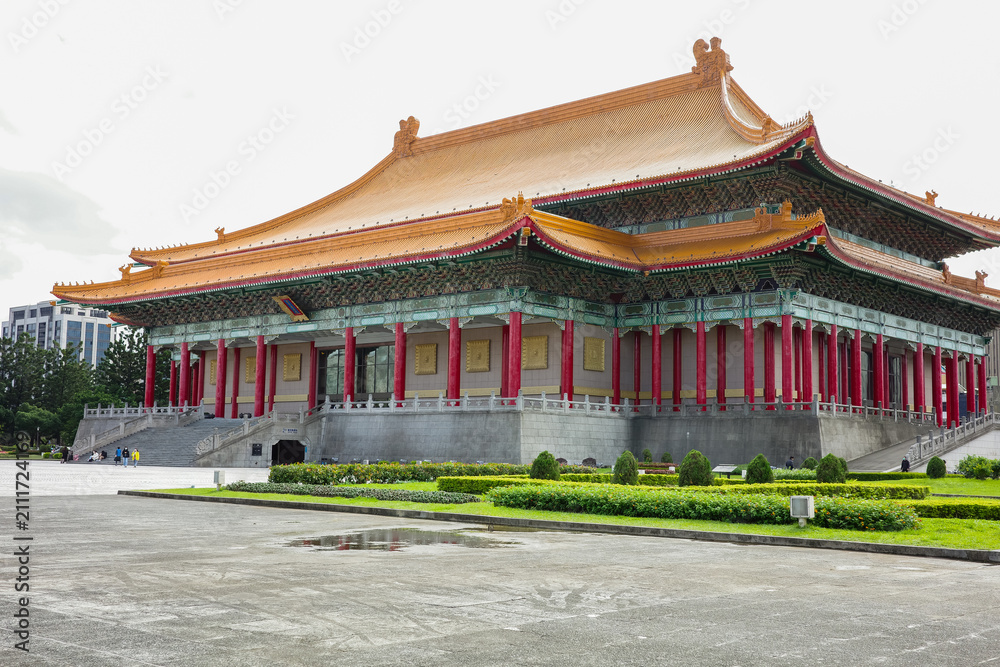 Fototapeta premium The majestic National Theater in Taipei, Taiwan, featuring traditional Chinese architecture with a striking orange-tiled roof and red pillars at Liberty Square.