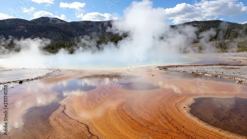 Vibrant Grand Prismatic Spring with colorful microbial mats and rising steam.