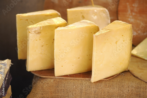 Obraz na płótnie Cheese on display at market in afternoon light
