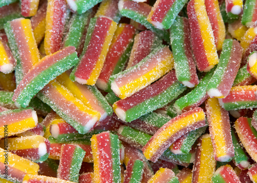 Close up of small pieces of licorice in multiple colors. Yellow, green and red. Sweet treat.