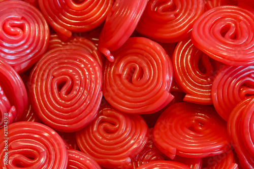 Close up on rolls of red licorice candy, piled. Above top view.