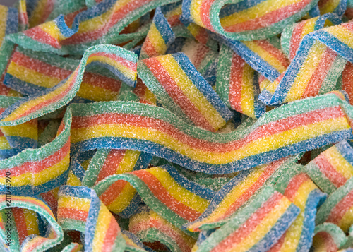 Close up on colorful sugar coated fruit roll ups in green, red, yellow and blue. Popular treat for kids.