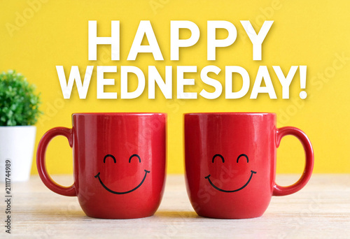 Cheerful red coffee mugs with smiley faces on a table celebrating happy wednesday morning vibes