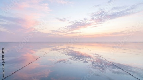 A wide, expansive surface reflects a breathtaking sunset sky. The smooth, reflective floor mirrors the pastel colors of the clouds, creating a seamless blend of sky and water.
