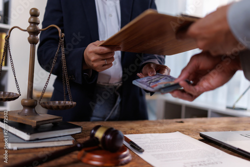 Принти на полотні Person accepting a large sum of cash from another individual, symbolizing illici