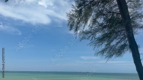 silhouette on tropical beach with calm blue sea and sky