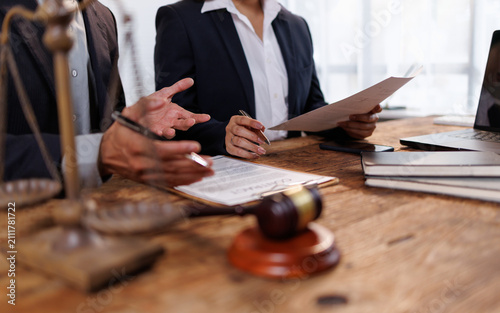 Vászonkép Legal professionals discussing contract terms, offering advice and consultation