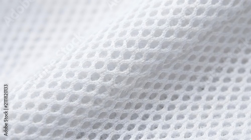Abstract white fabric texture with hexagonal pattern and soft light