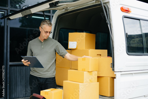 Professional courier holding parcel beside delivery van. Logistics, shipping, ecommerce, warehouse, last mile delivery, express service and reliable package transportation.