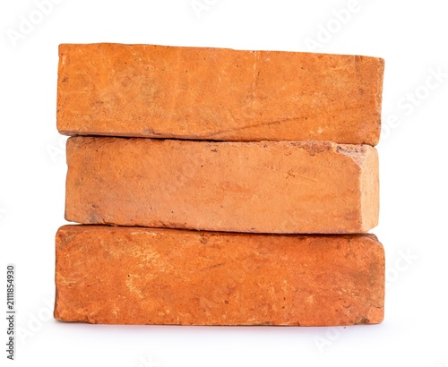 Photography Stacked rustic orange bricks for construction.