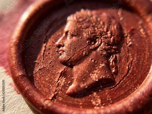 Old bronze coin showing a profile portrait of a roman emperor
