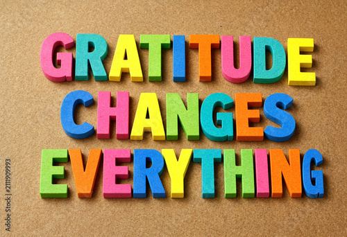 Colorful wooden letters spelling gratitude changes everything on a textured background for inspiration